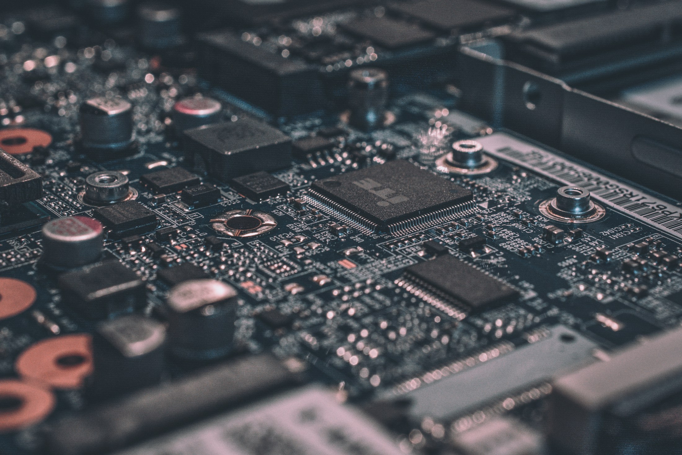Close view of a black circuit board and computer components