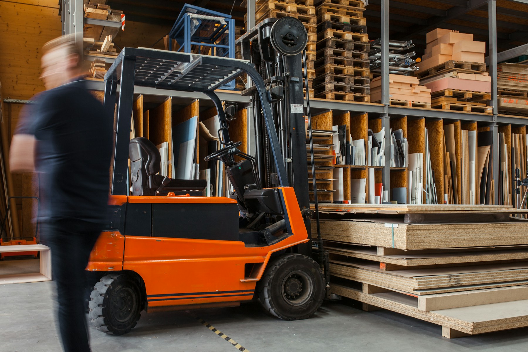 A yellow forklift in a large warehouse